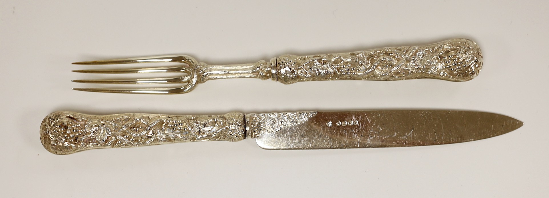 An ornate Victorian silver carving knife and fork, with fruiting vine handles, Francis Higgins, London, 1871/5, knife 27.1cm.